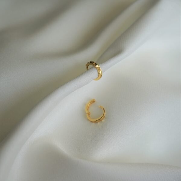 Goldohrringe mit Textur, elegante Accessoires für christlichen Stil.